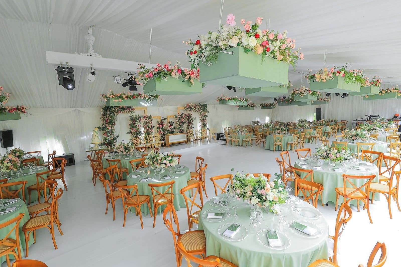 Elegant event setup with pink and green floral installations
