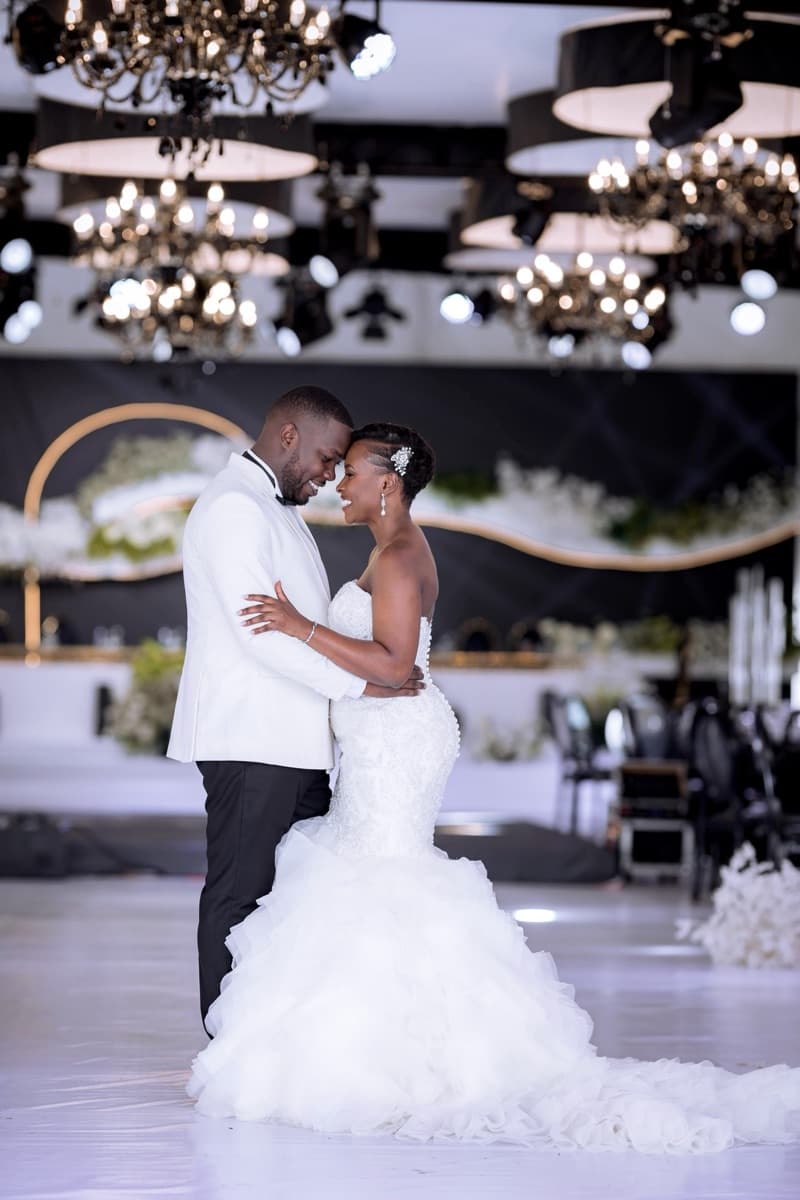 Grand black and gold reception venue with crystal chandeliers styled by Modern Charm